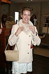 Annette Hanson trys on the merchandise  at Swinging Saturday at Cole Haan in Easthampton on 8-14-04.  photo by Rob Rich copyright 2004 516-676-3939  robwayne1@aol.com