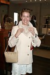 Annette Hanson trys on the merchandise  at Swinging Saturday at Cole Haan in Easthampton on 8-14-04.  photo by Rob Rich copyright 2004 516-676-3939  robwayne1@aol.comom