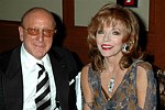 Clive Davis and Joan Collins at a party to celebrate the August nuptials of comic Daniella Rich and real-estate maven Richard Kilstock  at Pier 60 in Manhattan on October 7, 2004. photo by Rob Rich copyright 2004. 516-676-3939 robwayne1@aol.com